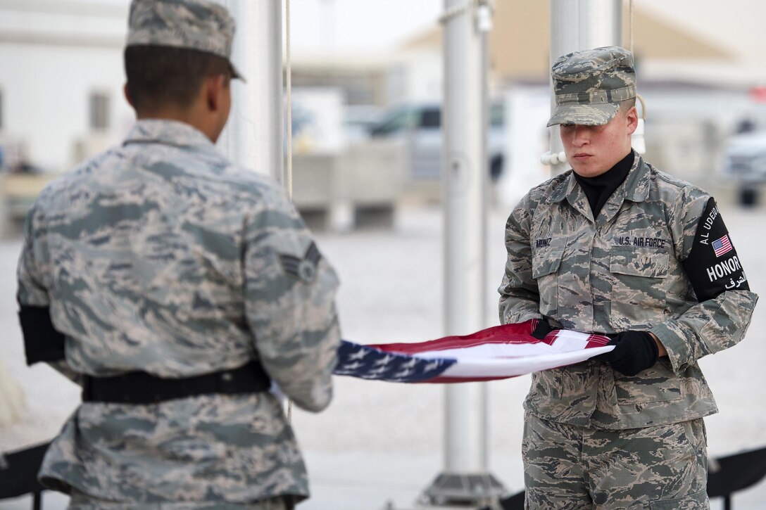 Air Force airmen prepare to fold the American flag during a 9/11 remembrance ceremony
