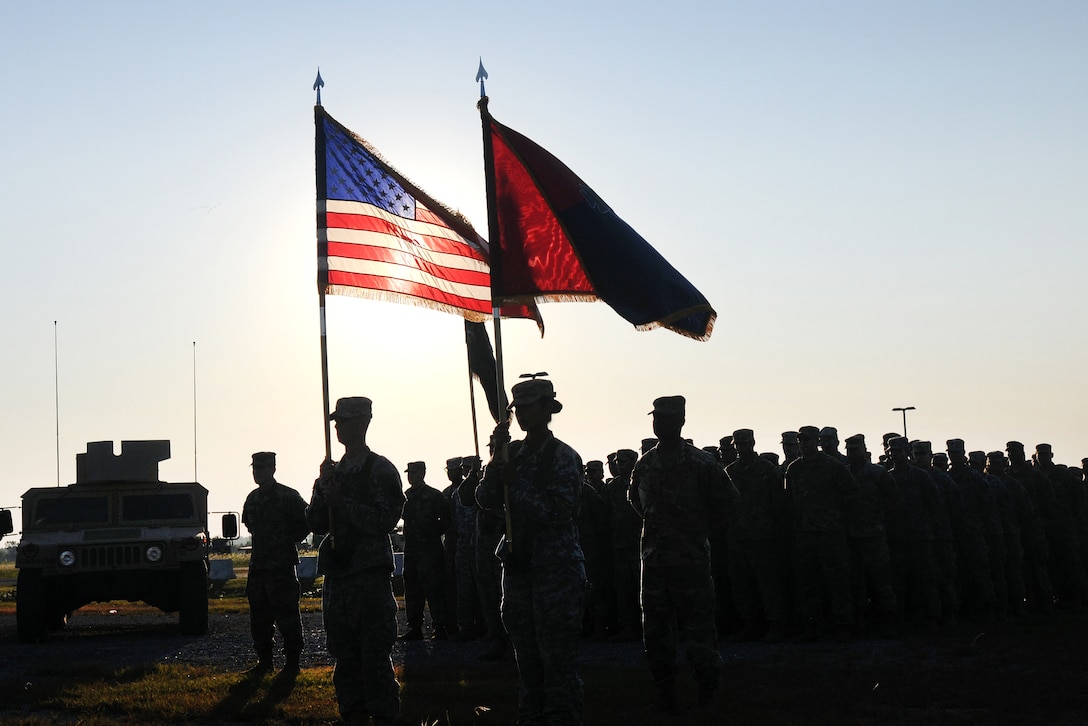 Soldiers and first responders stand in formation and hold a moment of silence for those who lost their lives in the 9/11 attacks during a remembrance ceremony