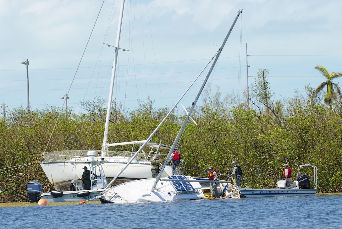 Teams with the Florida National Guard’s Chemical Biological Radiological Nuclear Emergency Response Force-Package and the Florida Fish and Wildlife Conservation Commission search a demolished sailboat.