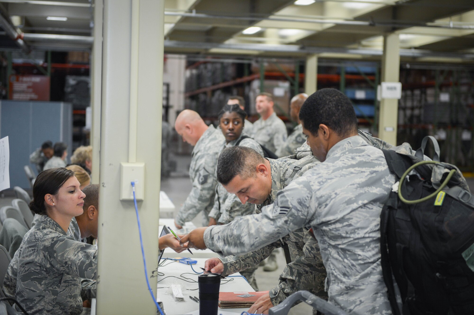 Reserve Citizen Airmen from the Air Force Reserve's 512th Airlift Wing process through  a deployment line in preparation for a deployment to Homestead Air Reserve Base, Fla., Sept. 12, 2017, in support of the Hurricane Irma humanitarian relief effort. The deployment line verified ID cards, immunizations and other records prior to departure. (U.S. Air Force photo by Senior Airman Damien Taylor)