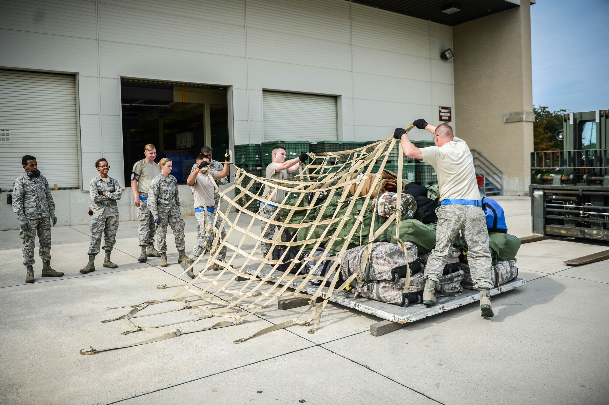 Reserve Citizen Airmen from the Air Force Reserve's 512th Airlift Wing, Dover Air Force Base, Del., secures cargo for departure to Homestead Air Reserve Base, Fla., Sept. 12, 2017, in support of the Hurricane Irma humanitarian relief effort. Each of the Dover reservists were allotted one personal bag for the deployment. (U.S. Air Force photo by Senior Airman Damien Taylor)