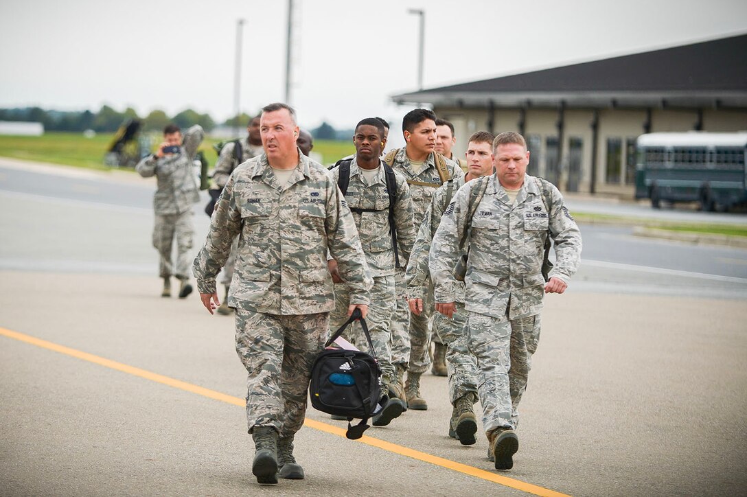 Reserve Citizen Airmen from the Air Force Reserve's 512th Airlift Wing, Dover Air Force Base, Del., walk towards a C-17 Globemaster III aircraft for departure to Homestead Air Reserve Base, Fla., in support of the Hurricane Irma humanitarian relief efforts. Dover reservists answered the Air Force Reserve's call to support the Hurricane Irma humanitarian relief effort within 24 hours.  (U.S. Air Force photo by Senior Airman Damien Taylor)