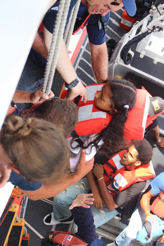 The Coast Guard helps families aboard the Coast Guard Cutter Valiant.