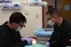 Maj. Jon Federspiel, chief of dental services with the 319th Medical Group, left, and Senior Airman Alexis Lopez, dental assistant with the 319th MDG, right, work together to simulate patient care, Sept. 7, 2017, at the medical treatment facility on Grand Forks Air Force Base, N.D. During a typical procedure, a dentist and dental assistant work together to help prioritize customer care and treat patients effectively.