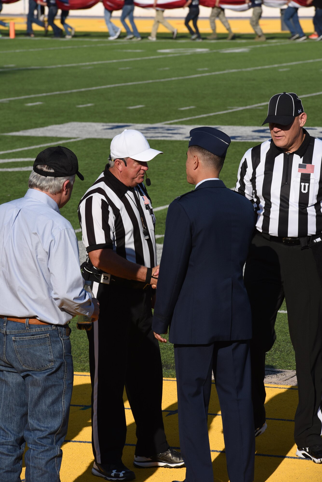 U.S Air Force Col. Ricky Mills, 17th Training Wing commander, greets the referees during the Military Appreciation Day game at Angelo State University’s LeGrand Stadium in San Angelo, Texas, Sept. 9, 2017. The game was between ASU and Northern Michigan University and was a rematch of last year’s ASU victory. (U.S. Air Force photo by Airman Zachary Chapman/Released)