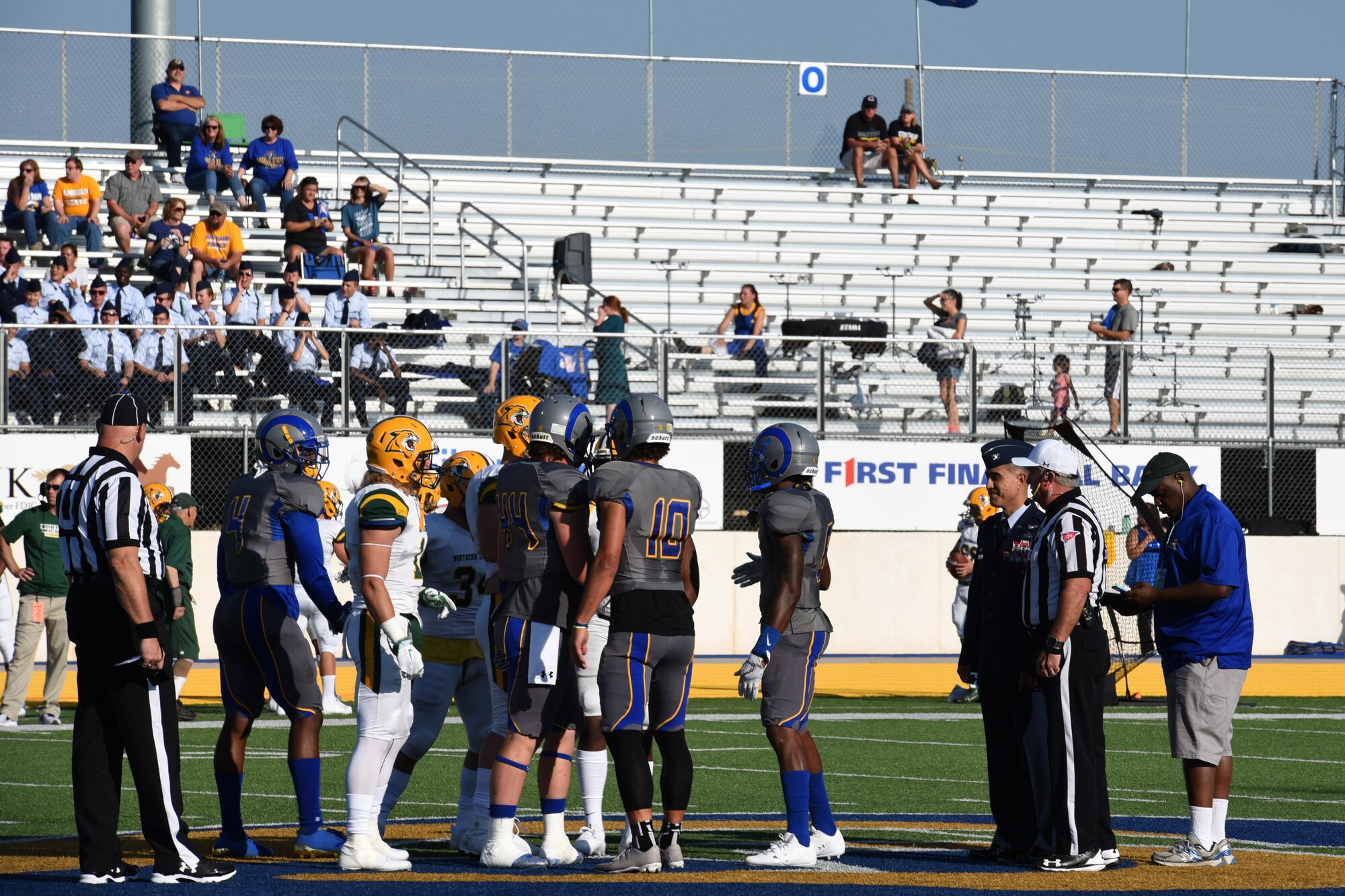 U.S. Air Force Col. Ricky Mills, 17th Training Wing commander, prepares for the coin toss to begin the Military Appreciation Day game at the Angelo State University’s LeGrande Stadium in San Angelo, Texas, Sept. 9, 2017. During the halftime ceremony, Mills also swore in approximately 50 delayed entry program individuals from different branches of the military. (U.S. Air Force photo by Airman Zachary Chapman/Released)