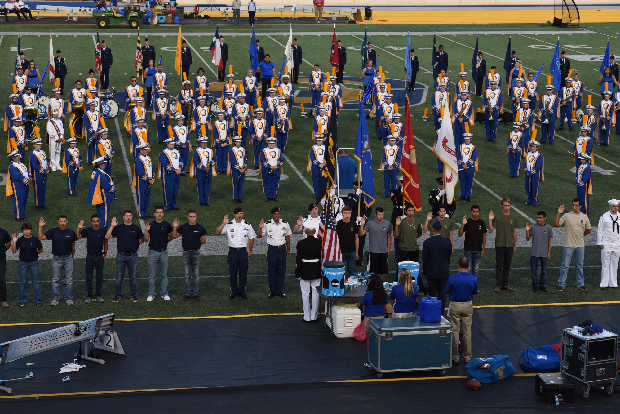 During halftime of the Military Appreciation Day game, approximately 50 delayed enlistment program individuals take the Oath of Enlistment at Angelo State University’s LeGrand in San Angelo Tex. Sept. 9, 2017. U.S. Air Force Col. Ricky Mills, 17th Training Wing commander, administered the oath to future Soldiers, Sailors, Airmen and Marines. (U.S. Air Force photo by Airman Zachary Chapman/Released)