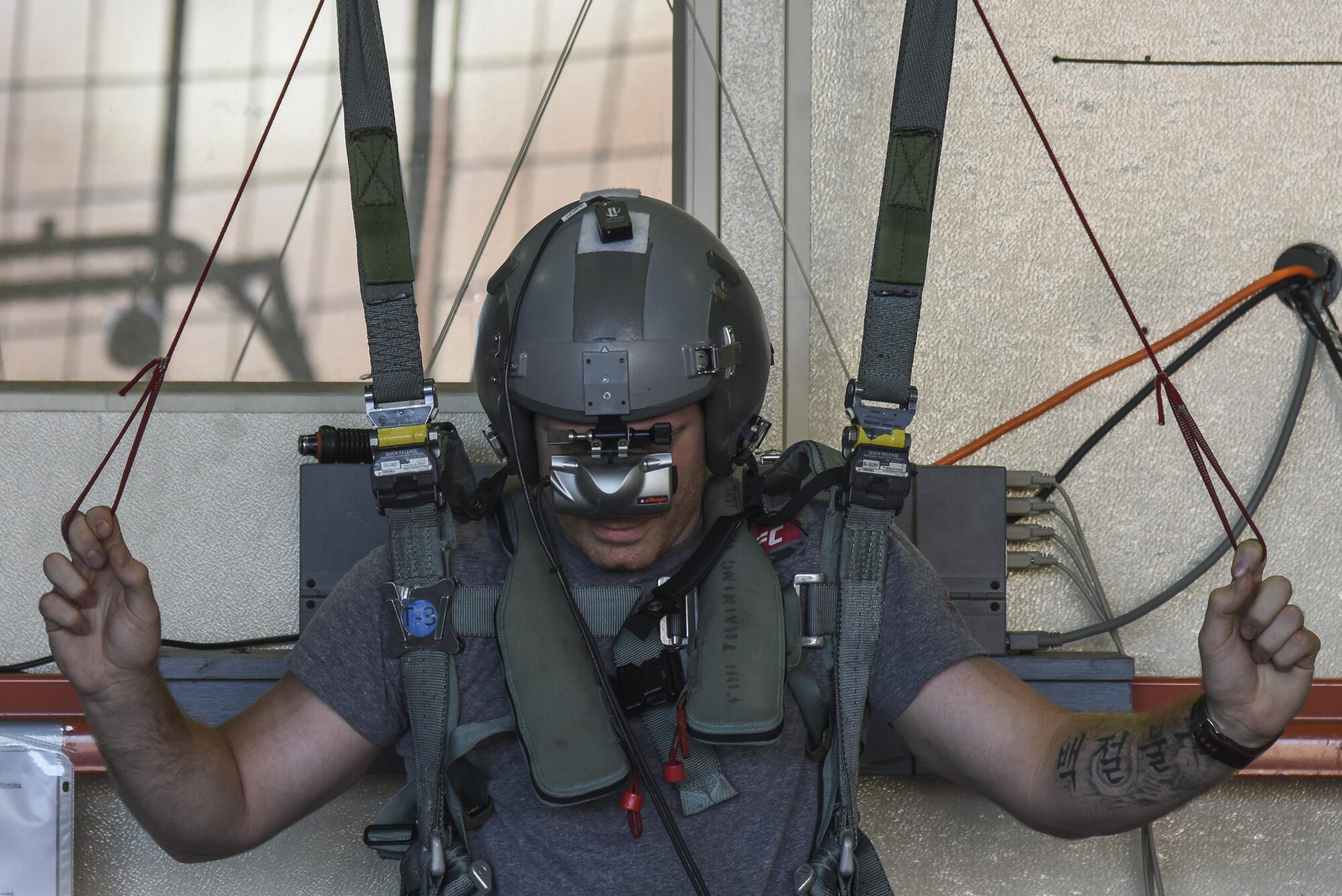 Paul Felder, Ultimate Fighting Championship lightweight division fighter, operates a parachute simulator at Joint Base Langley-Eustis, Va., Sep. 8, 2017.