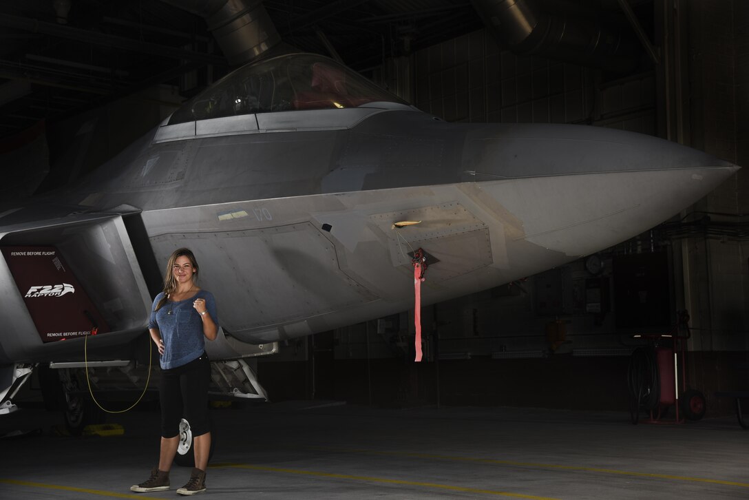 Miesha Tate, retired Ultimate Fighting Championship Bantamweight division champion, poses in front of an F-22 Raptor during a tour of Joint Base Langley-Eustis, Va., Sep. 8, 2017.
