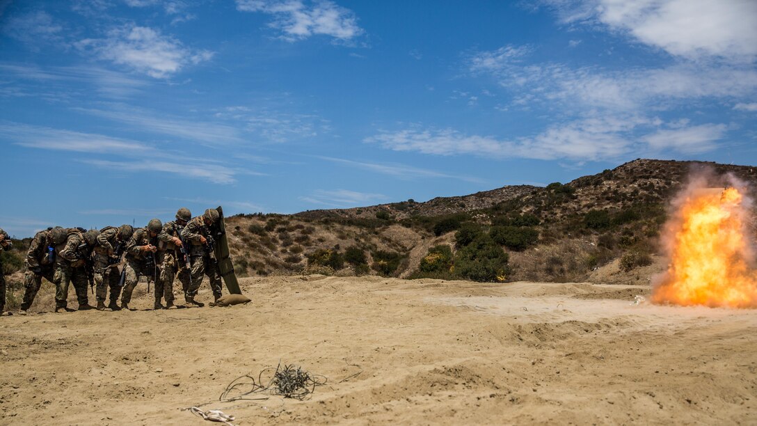 Marines with Combat Service Support Company, I Marine Expeditionary Force Information Group, line up behind a ballistic blanket before performing a simulated door breach at Camp Pendleton, Calif., Aug. 1, 2017. The Marines conducted the training to further develop their combat capabilities as part of the stand-up of the Marine Support Battalion. The mission of the new unit is to provide extensive logistical support to I MEF and I Marine Expeditionary Brigade command element, both in garrison and on deployment.