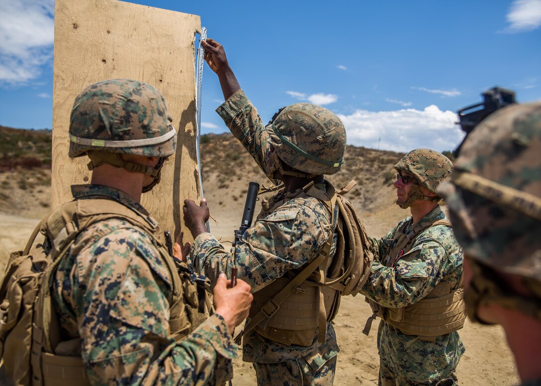 Combat engineers with Combat Service Support Company, I Marine Expeditionary Force Information Group, instruct Marines on how to set up a door breaching explosive charge at Camp Pendleton, Calif., Aug. 1, 2017. The Marines conducted the training to further develop their combat capabilities as part of the stand-up of the Marine Support Battalion. The mission of the new unit is to provide extensive logistical support to I MEF and I Marine Expeditionary Brigade command element, both in garrison and on deployment. Photo by Lance Cpl. Cutler Brice.