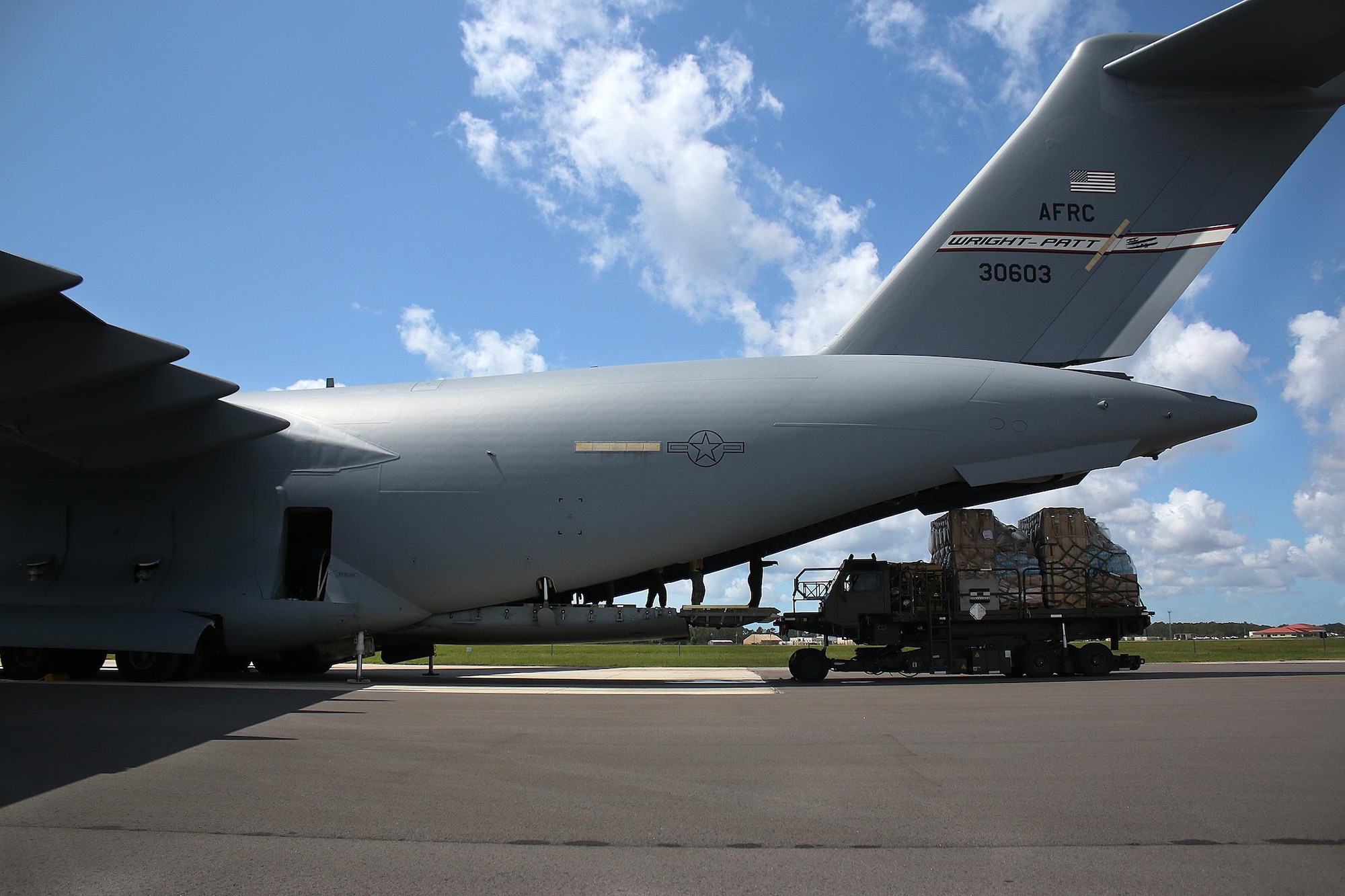 Members of the 89th Airlift Squadron, Wright-Patterson Air Force Base, Ohio, and the 6th Logistics Readiness Squadron, MacDill Air Force Base, Florida, unload cargo from a 445th Airlift Wing C-17 Globemaster III that was transported from Joint Base McGuire-Dix-Lakehurst, New Jersey to MacDill Air Force Base, Florida to aid in the Hurricane Irma relief efforts September 12,  2017.