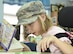 A Lone Star Elementary School student shares 301st Medical Squadron Master Sgt. Nate McReynolds’ military cap while they read together during a visit Aug. 23, 2017, in Keller, Texas. Eight Reserve medical Airmen visited the school to connect and read to students as part their unit's community outreach program. (U.S. Air Force photo by Ms. Julie Briden-Garcia)