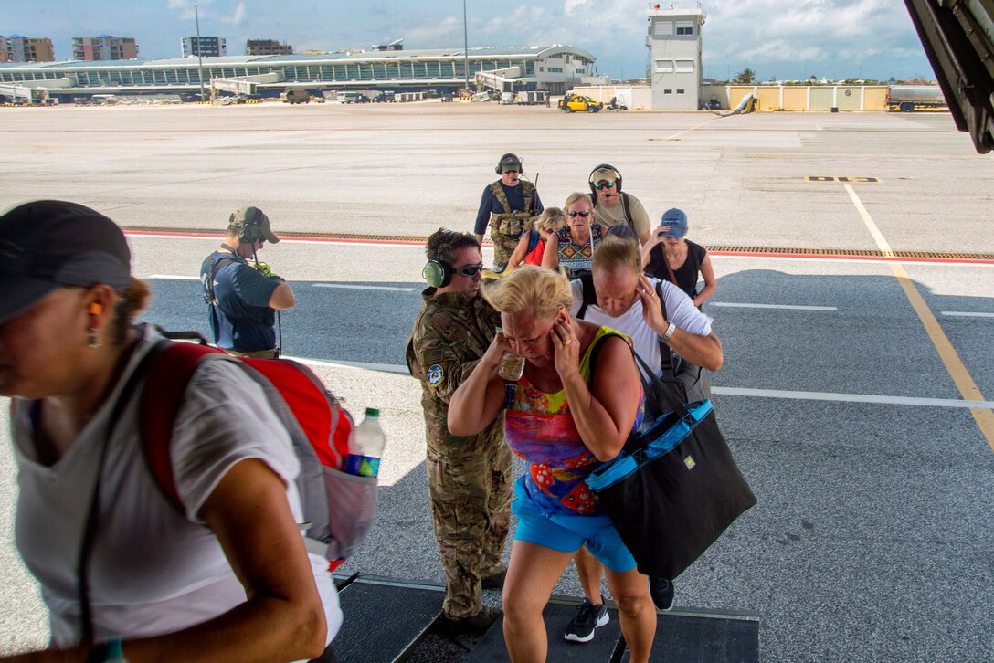 American evacuees board a HC-130 Hercules aircraft at the Princess Juliana International Airport on St. Maarten before taking off
