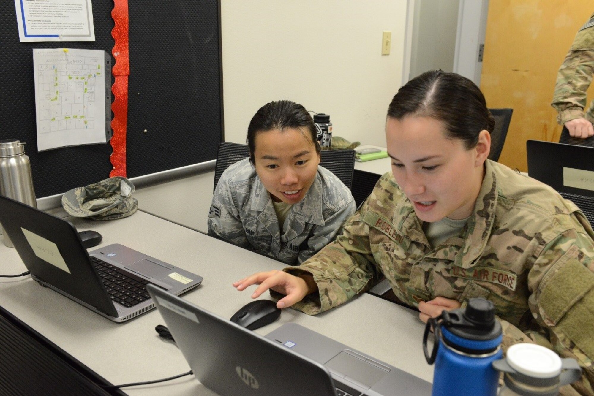 Staff Sgt. Ashlie Robledo and Senior Airman Thao Bui, 11th Special Operations Intelligence Squadron analysts, participate in a data-tagging training event Aug. 24, 2017, at Hurlburt Field, Fla. Data-tagging is designed to assist them with analyzing imagery. (U.S. Air Force photo by Senior Airman Lynette M. Rolen)