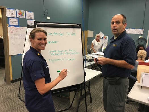 Coast Guard Lt. Commander Karen Kutkiewicz and Federal
Emergency Management Agency reservist Matt Proietti work on a writing plan Sept. 6, 2017, at the Hurricane Harvey Joint Field Office in Austin, Texas. Proietti, a Penn Valley, California, resident, is superintendent of 4th Combat Camera Squadron, Joint Base Charleston, South Carolina. Kutkiewicz is a public affairs officer at the Coast Guard's 1st District Headquarters in Boston. Both are graduates of the military's Defense Information School. (courtesy photo)