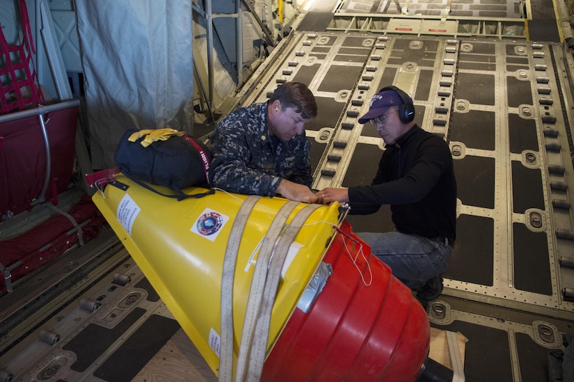 Navy Lt. Cmdr. John Woods, from the Office of Naval Research, reserve component, and Ignatius Rigor from the University of Washington prepare an Air-Deployable Expendable Ice Buoy for deployment in the high Arctic Ocean near the North Pole.