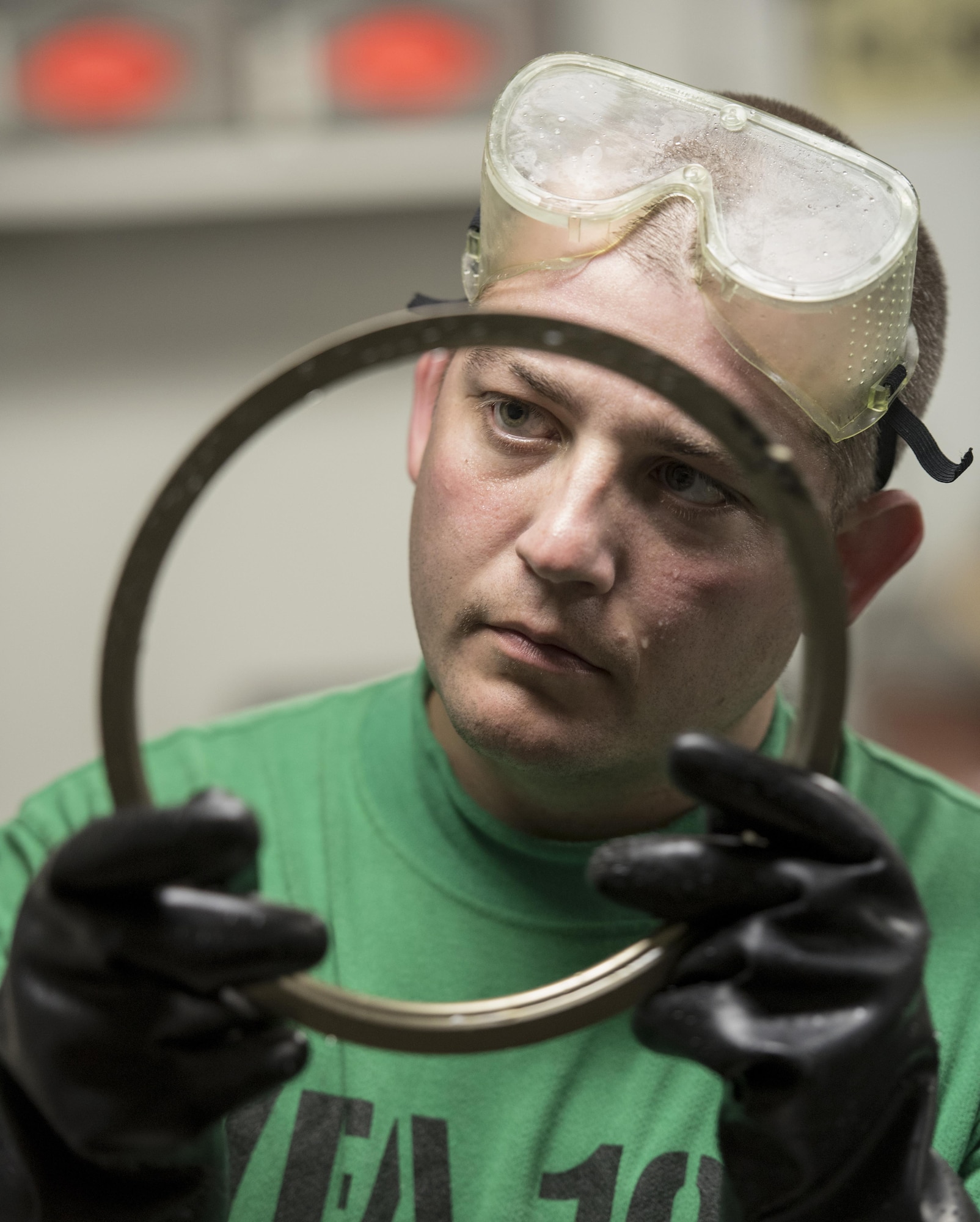 U.S. Air Force Staff Sgt. Mark Gower, 33rd Maintenance Squadron wheel and tire technician, inspects a flange retainer assembly from an F-35C Lightning II nose wheel Sept. 6, 2017, aboard the Nimitz-class aircraft carrier USS Abraham Lincoln (CVN 72). Two Airmen and two Sailors from 33rd MXS qualified Abraham Lincoln Sailors to operate F-35 support equipment bringing the U.S. Navy one step closer to initial operations capability. (U.S. Air Force photo by Staff Sgt. Peter Thompson/Released)