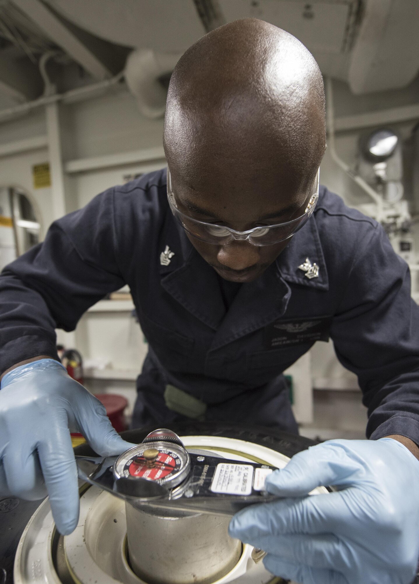 U.S. Navy Aviation Structural Mechanic 1st Class Jason Davidson, USS Abraham Lincoln (CVN 72) tightens a screw on an F-35C Lightning II nose wheel Sept. 6, 2017, aboard the ship. Two Airmen and two Sailors from 33rd Maintenance Squadron qualified Abraham Lincoln Sailors to operate F-35 support equipment bringing the U.S. Navy one step closer to initial operations capability. (U.S. Air Force photo by Staff Sgt. Peter Thompson/Released)