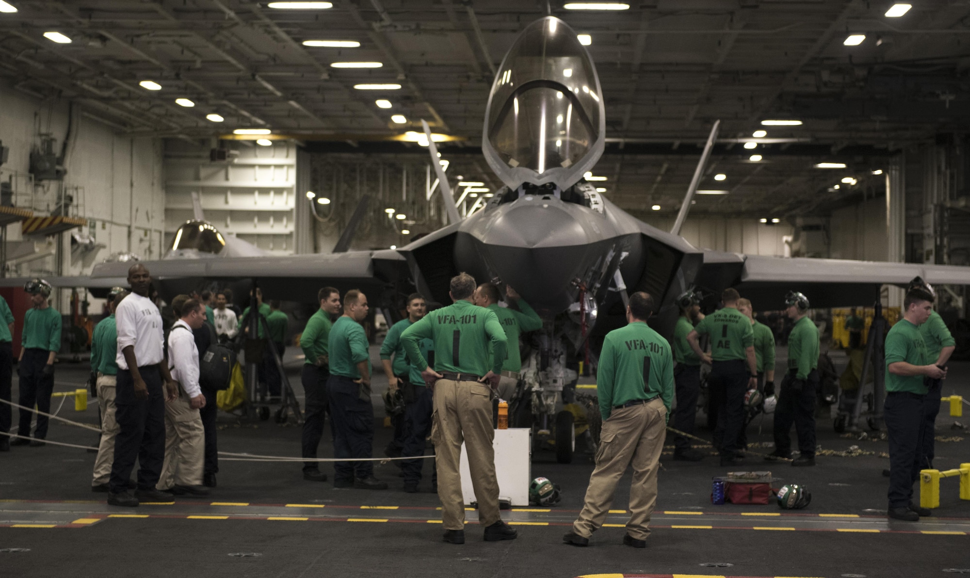 Members of Strike Fighter Squadron (VFA) 101 and VFA-125 stand near F-35Cs Lightning II Sept. 6, 2017, while aboard the Nimitz-class aircraft carrier USS Abraham Lincoln (CVN 72). Two Airmen and two Sailors from 33rd Maintenance Squadron qualified Abraham Lincoln Sailors to operate F-35 support equipment bringing the U.S. Navy one step closer to initial operations capability. (U.S. Air Force photo by Staff Sgt. Peter Thompson/Released)