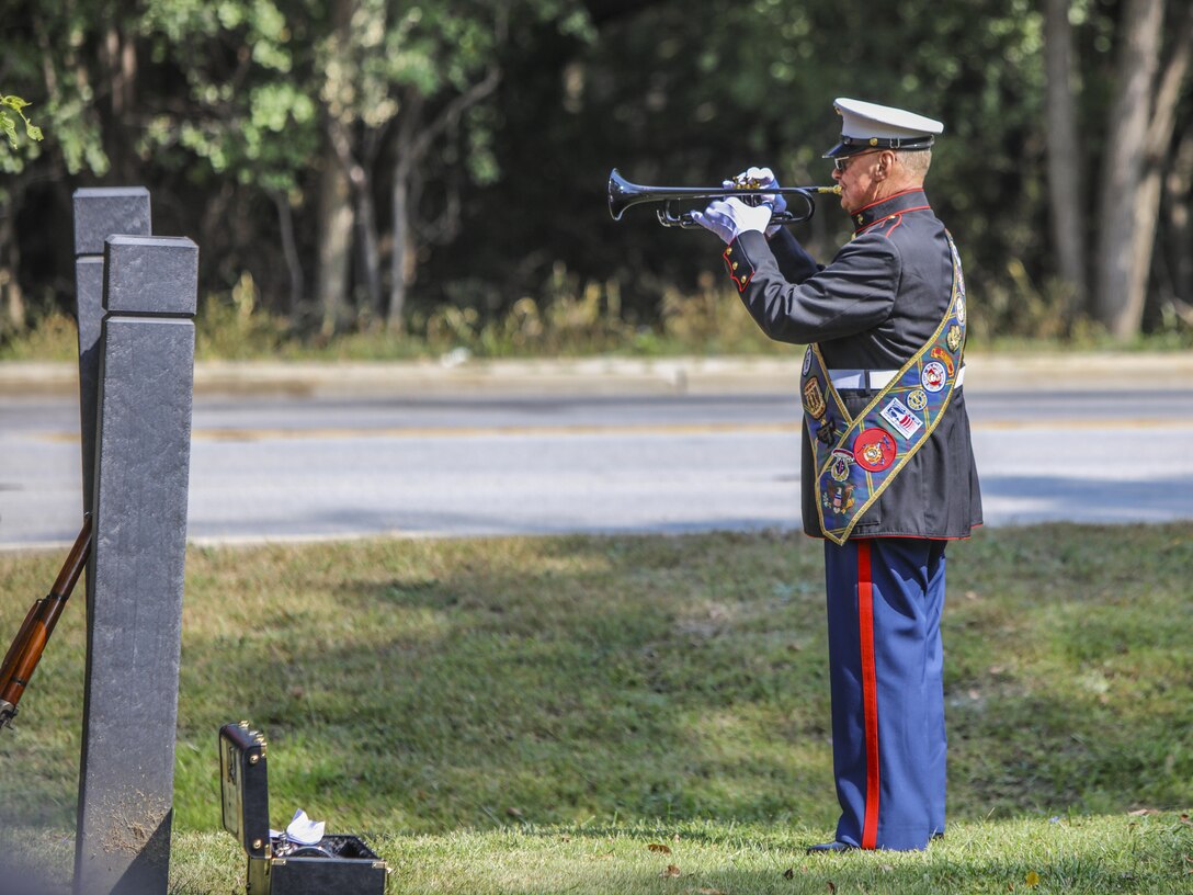 Retired Gunnery Sgt. Tom Day plays Taps during a dedication ceremony in Glenview, Illinois, Sept. 12, honoring a Marine Vietnam veteran.  Town residents and city officials attended the bridge dedication ceremony honoring Cpl. Donald W. Bollman, a Purple Heart recipient who was killed in action in South Vietnam March 1, 1967. (U.S. Marine Corps photo by Lance Cpl. Quavaungh Pointer/Released)