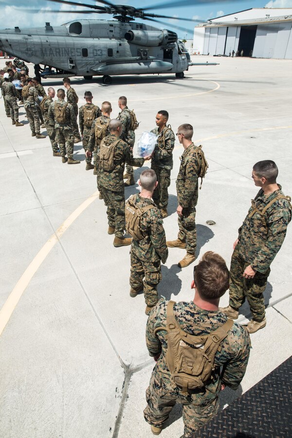 Battalion Landing Team 2nd Battalion, 6th Marine Regiment, 26th Marine Expeditionary Unit (MEU) and Marine Heavy Helicopter Squadron (HMH) 461 handle bottle water at Naval Air Station Key West, Fl., Sept. 12, 2017. Marines and Sailors from the 26th Marine Expeditionary Unit (MEU) and Marine Heavy Helicopter Squadron (HMH) 461 handled and distributed food, water, and supplies in support of the Federal Emergency Management Agency in the aftermath of Hurricane Irma. (U.S. Marine Corps photo by Cpl. Jered T. Stone)