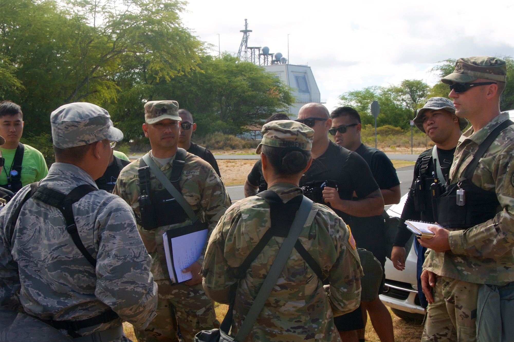 Airmen and soldiers from the Hawaii National Guard's 93rd Civil Support Team gather for a mission brief during Kauai County Exercise 2017