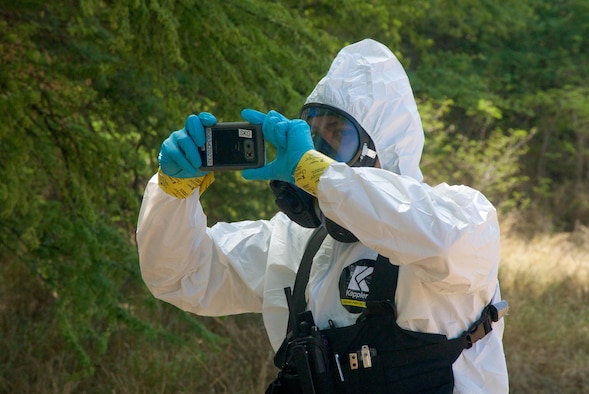 A Joint Hazard Assessment Team member from the 93rd Civil Support Team, Hawaii National Guard, takes a picture of a simulated hot zone as part of his hazmat survey