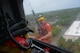 Petty Officer 2nd Class Graham McGinnis, an aviation survival technician, responds to a rescue request in Houston, Aug. 27, 2017. The Coast Guard partners with local Emergency Operations Centers and established an Incident Command Post to manage search and rescue operations. U.S. Coast Guard courtesy photo by Petty Officer 2nd Class Bob Hovey