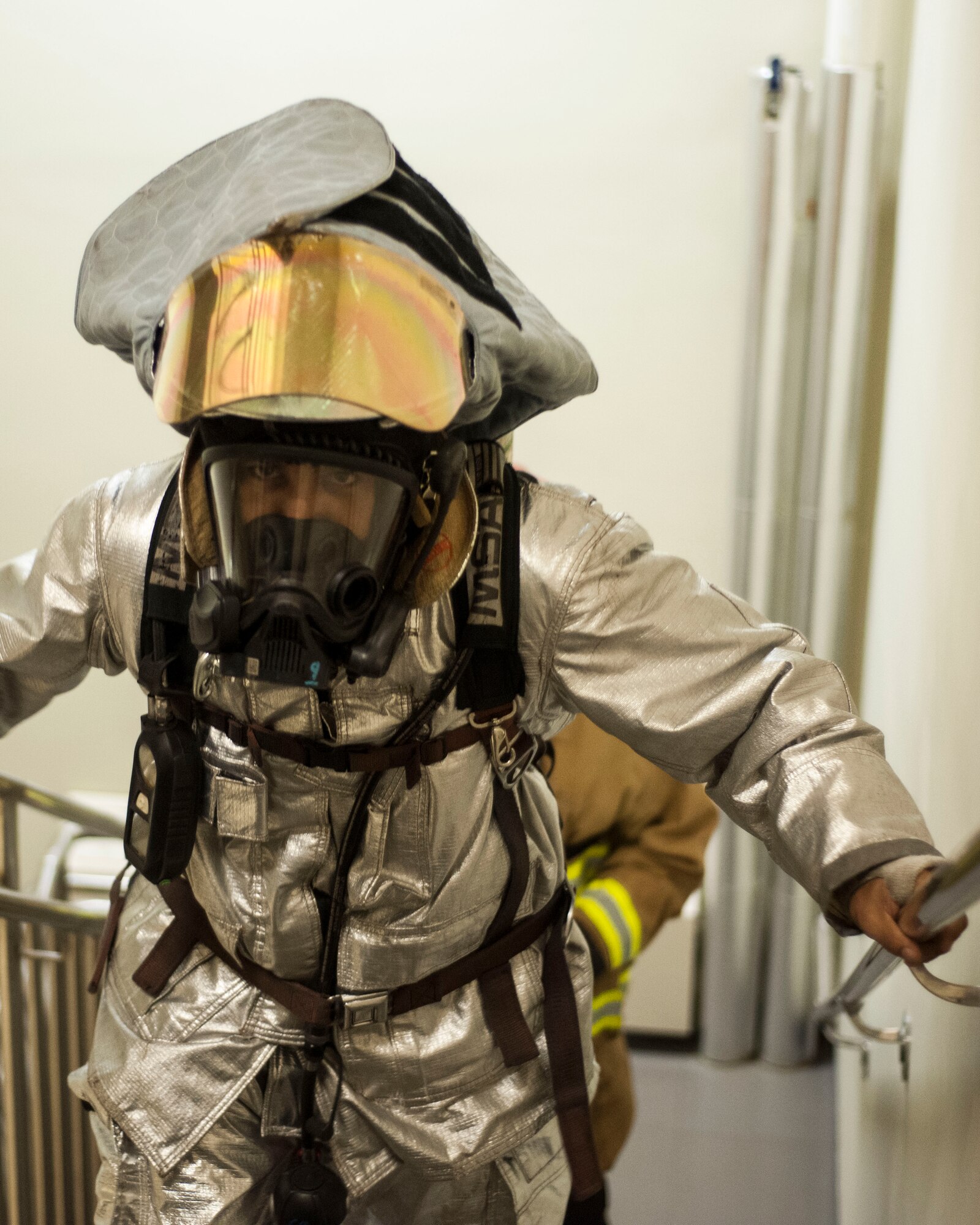 U.S. Air Force Staff Sgt. Alex Vasquez, 8th Civil Engineer Squadron firefighter, climb stairs during the 9/11 Remembrance Stair Climb at Kunsan Air Base, Republic of Korea, Sept. 11, 2017. During the event, Airmen climb the seven-story dormitory donned in their emergency response gear while holding the names of those who perished while reacting to the terrorist attack. (U.S. Air Force photo by Staff Sgt. Victoria H. Taylor)