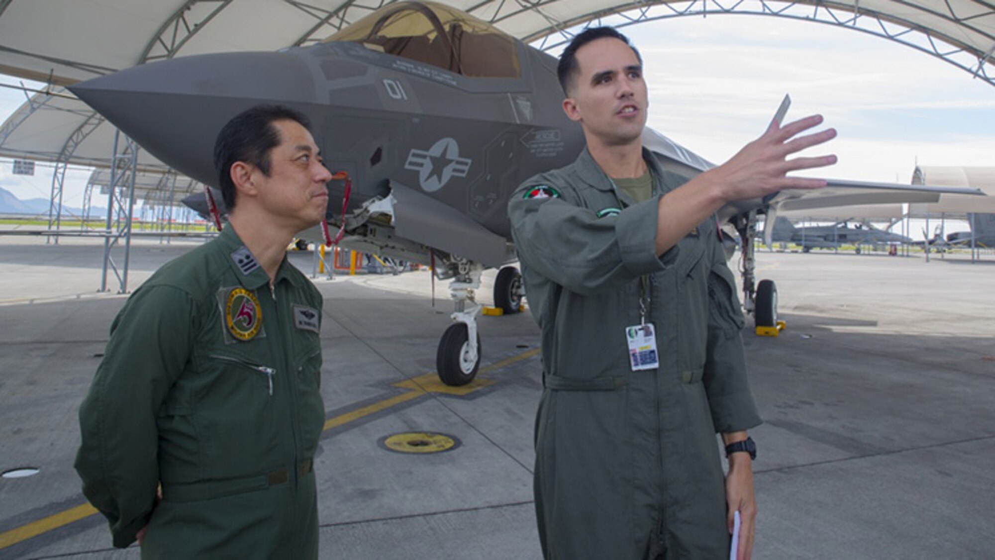 U.S. Marine Corps Maj. Adam Wellington, right, aircraft maintenance officer for Marine Fighter Attack Squadron 121, answers questions for Japan Air Self-Defense Force Lt. Col. Mamoru Yamaura, F-35A Lightning II program office chief with Third Air Wing, during an educational tour and class centered on the F-35B Lightning II at Marine Corps Air Station Iwakuni, Japan, Sept. 13, 2017.
