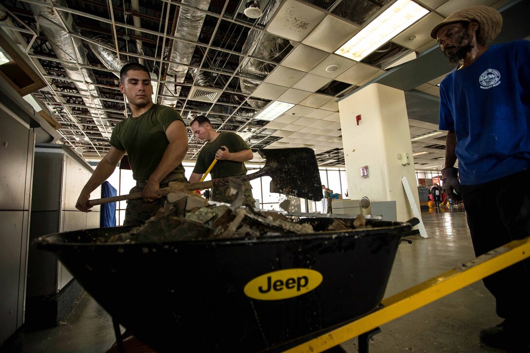 U.S. Marines with the 26th Marine Expeditionary Unit assist in cleaning debris caused by Hurricane Irma at the Cyril E. King Airport, St. Thomas, U.S. Virgin Islands, Sept. 13, 2017. The Department of Defense is assisting the Federal Emergency Management Agency in hurricane relief efforts by providing food, water and essential needs to the U.S. Virgin Islands. (U.S. Marine Corps photo by Lance Cpl. Tojyea Matally)