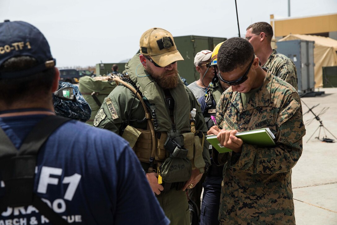 U.S. Marines with the 26th Marine Expeditionary Unit work with members of the Federal Emergency Management Agency and other federal and local officials at the Cyril E. King Airport, St. Thomas, U.S. Virgin Islands, Sept. 13, 2017. The Department of Defense is assisting the Federal Emergency Management Agency in hurricane relief efforts by providing food, water and essential needs to the U.S. Virgin Islands. (U.S. Marine Corps photo by Lance Cpl. Tojyea Matally)