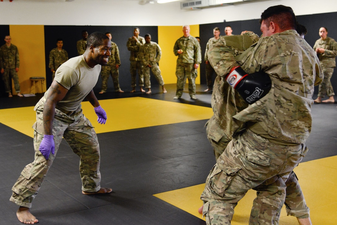 Staff Sgt. Robert Ward, left, observes his students conducting punching drills during a basic combatives course