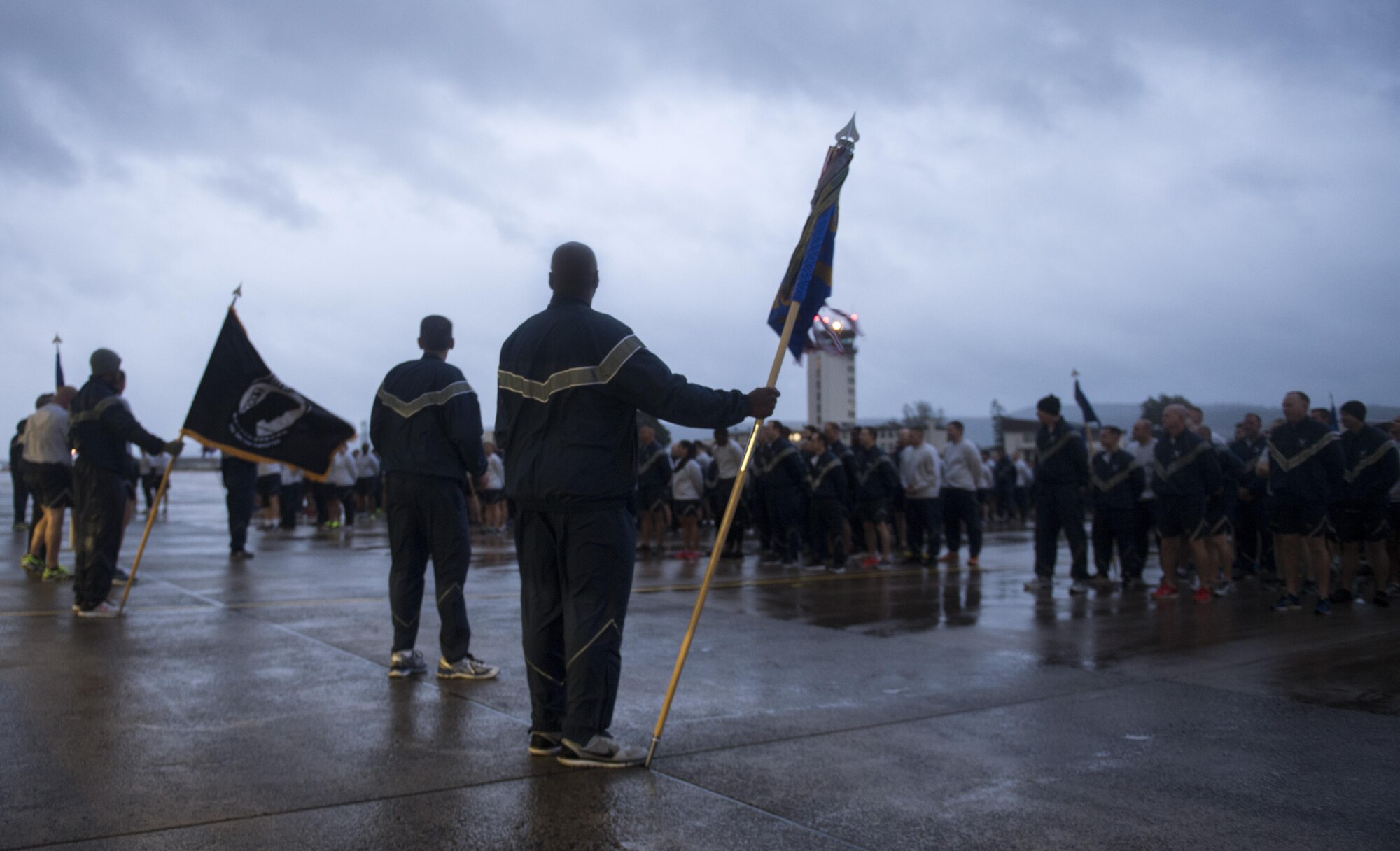 U.S. Airmen assigned to the 86th Airlift Wing, 521st Air Mobility Operations Wing, and 435th Air Ground Operations Wing stand before a formation comprised of Airmen assigned to the three wings during the Tri-Wing POW/MIA Memorial Run on Ramstein Air Base, Germany, Sept. 13, 2017. The run is held each year in September to honor service members who were or are prisoners of war or missing in action. (U.S. Air Force photo by Senior Airman Tryphena Mayhugh)