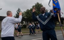 U.S. Air Force Chief Master Sgt. David E. Satchell, 521st Air Mobility Operations Wing command chief, high-fives a participant in the Tri-Wing POW/MIA Memorial Run as he runs to the finish line on Ramstein Air Base, Germany, Sept. 13, 2017. The run was held in honor of National Prisoners of War/Missing in Action Day, which is observed every year on the third Friday in September. (U.S. Air Force photo by Senior Airman Tryphena Mayhugh)