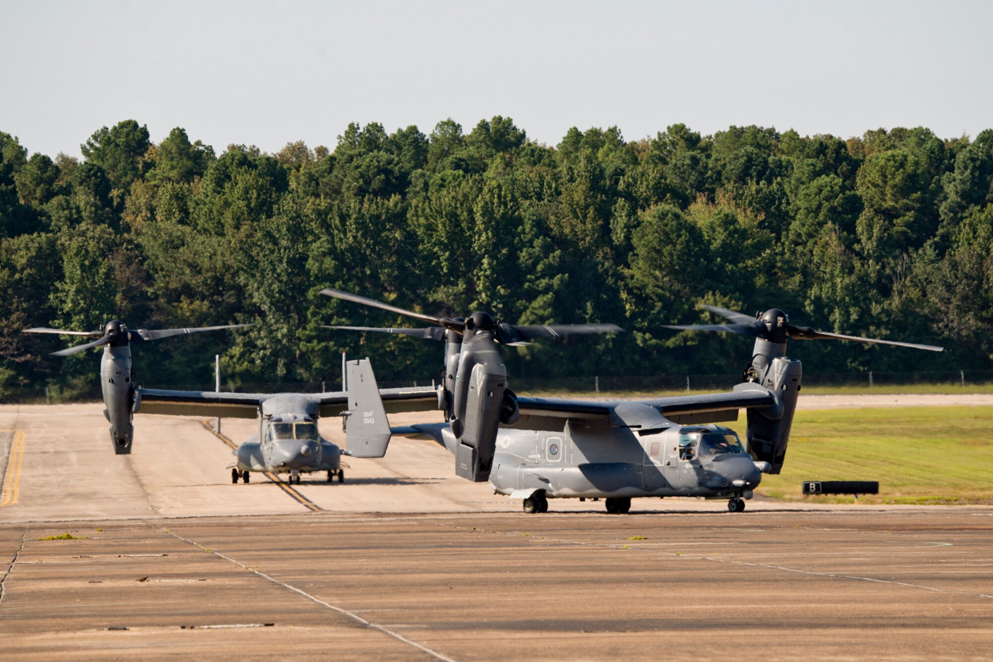 Two CV-22 Osprey, assigned to Hurlburt Field, Fla., taxi to parking spots on the ramp at Little Rock Air Force Base, Ark., Sept. 9, 2017. The aircraft is a tiltrotor aircraft that combines the vertical takeoff, hover and vertical landing qualities of a helicopter with the long-range, fuel efficiency and speed characteristics of a turboprop aircraft. Its mission is to conduct long-range infiltration, exfiltration and resupply missions for special operations forces. (U.S. Air Force photo by Master Sgt. Jeff Walston)