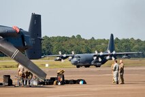 An MC-130H Combat Talon II taxis past a CV-22 Osprey to its parking spot Sept. 9, 2017, at Little Rock Air Force Base, Ark. The MC-130H provides infiltration, exfiltration, and resupply of special operations forces and equipment in hostile or denied territory. Secondary missions include psychological operations and helicopter and vertical lift air refueling. (U.S. Air Force photo by Master Sgt. Jeff Walston)