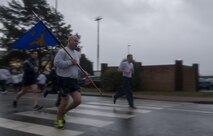 U.S. Air Force Chief Master Sgt. Aaron D. Bennett, 86th Airlift Wing command chief, runs while carrying the 86th AW’s guidon during the Tri-Wing POW/MIA Memorial Run on Ramstein Air Base, Germany, Sept. 13, 2017. The run was held to honor prisoners of war and missing in action service members and was attended by Airmen assigned to the 86th AW, 521st Air Mobility Operations Wing, and 435th Air Ground Operations Wing. (U.S. Air Force photo by Senior Airman Tryphena Mayhugh)