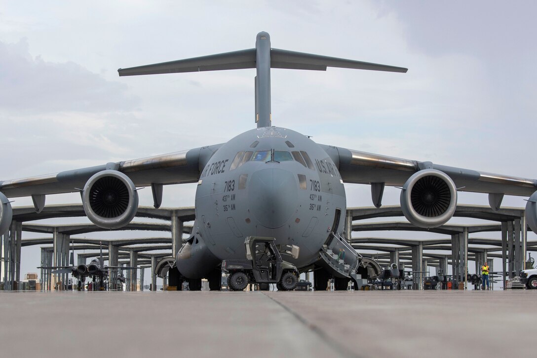 A C-17 Globemaster III is prepared to be loaded with a mobile air traffic control tower system