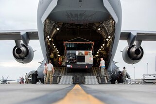Airmen load a mobile traffic control tower system onto a C-17 Globemaster III