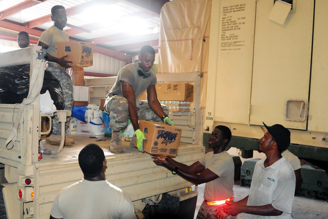 Virgin Islands Army National Guardsmen unload goods donated from Puerto Rico