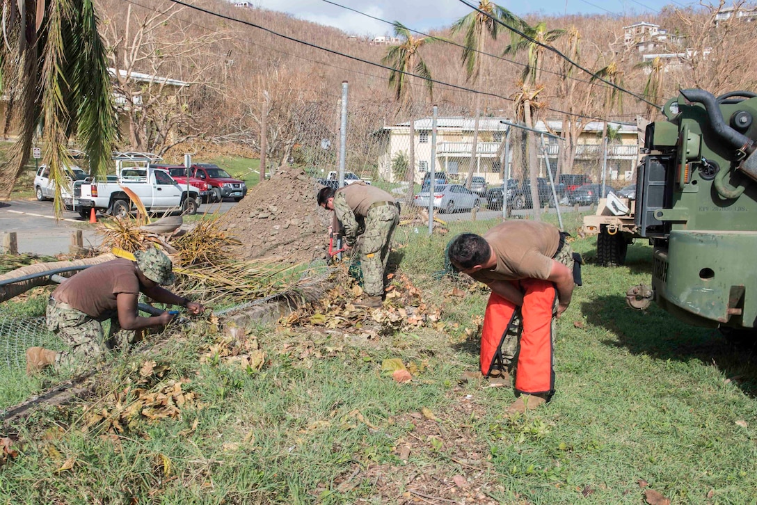 Sailors clear debris near a roadway in St. John, Virgin Islands