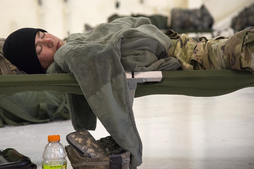 A Georgia Army National Guardsman rests, Sept. 13, 2017, at Moody Air Force Base, Ga. Units from the 48th Infantry Brigade Combat Team and Joint Task Force 781st Chemical, Radiological, Nuclear, Explosive Response Package stayed the night at Moody before heading to Orlando, Fla., to provide humanitarian relief for the victims of Hurricane Irma. (U.S. Air Force photo by Airman 1st Class Erick Requadt)