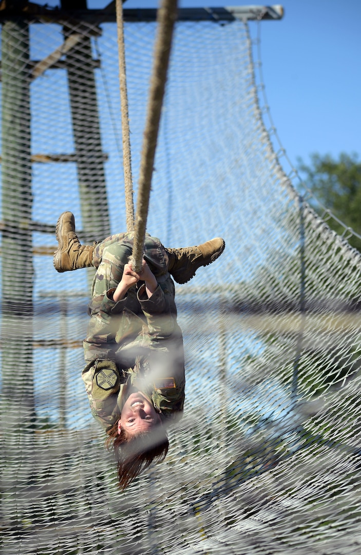 U.S. Army Installation Management Command 2017 Soldier of the Year Spc. Lillian Lewis of Fort Riley, Kan., maneuvers through the obstacle course at Joint Base San Antonio-Camp Bullis during the Best Warrior Competition. Soldiers will tackle at least a portion of the same obstacle course in the 2017 BOSS Strong Championship Sept. 11-24 in San Antonio.