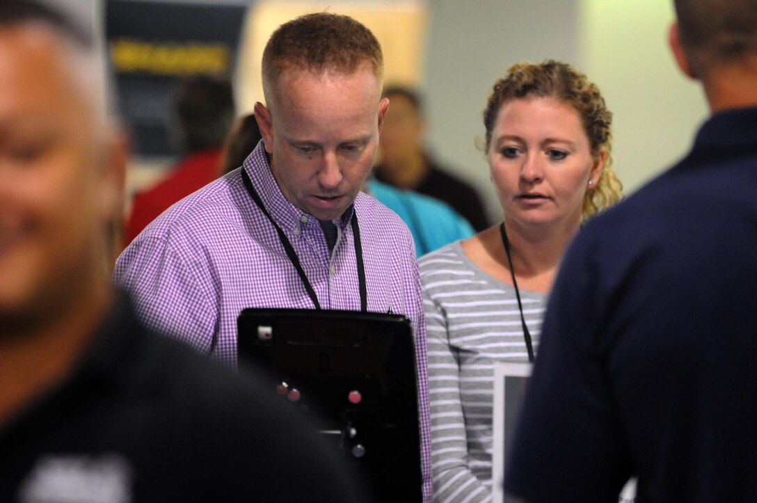 Staff Sgt. Mark Sobol, a pre-deployment attendee at the Yellow Ribbon event, uses ones of the devices at a community partner booth during a break between presentations in Minneapolis September 9.