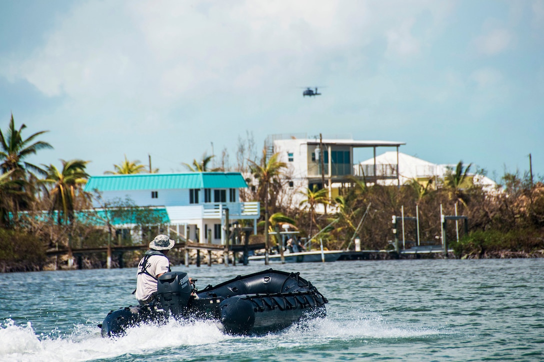 Spc. Steven Knipp conducts a maritime reconnaissance and rescue mission in a Zodiac boat.