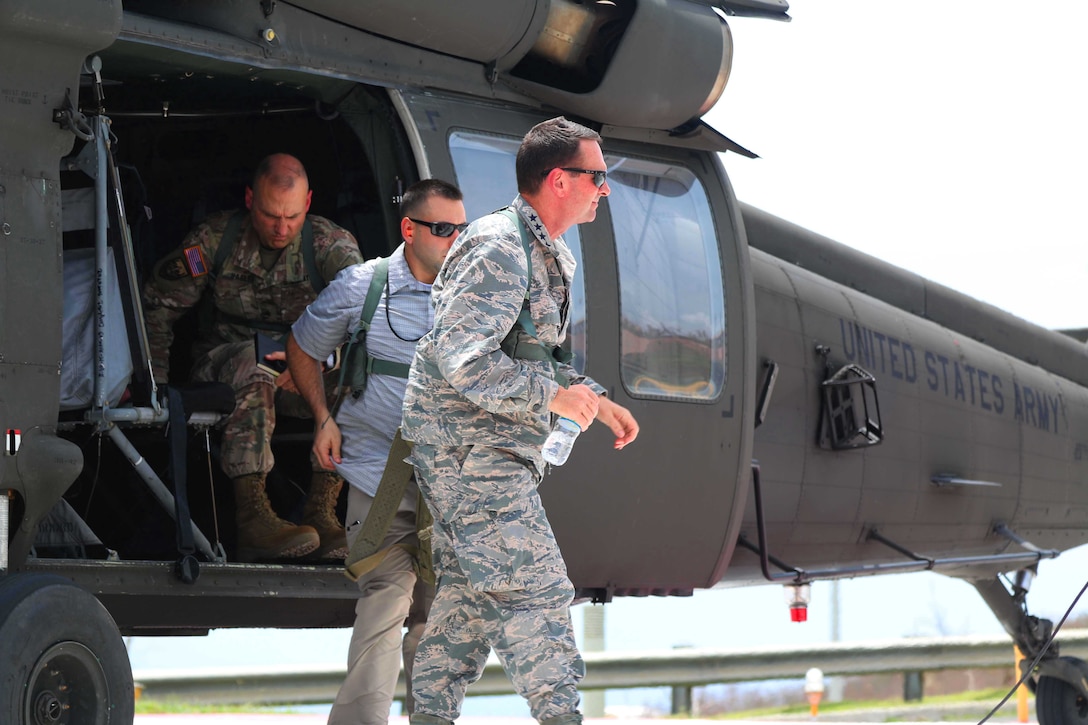 An Air Force general walks away from a helicopter.