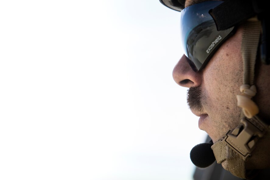A pararescueman from the 48th Rescue Squadron scans the ground from an HH-60G Pave Hawk, Sept. 12, 2017, in the skies over South Florida. The 563d Rescue Group prepositioned aircraft and personnel in support of FEMA and U.S. Northern Command for rescue operations after Hurricane Irma made landfall in Florida. (U.S. Air Force photo by Staff Sgt. Ryan Callaghan)