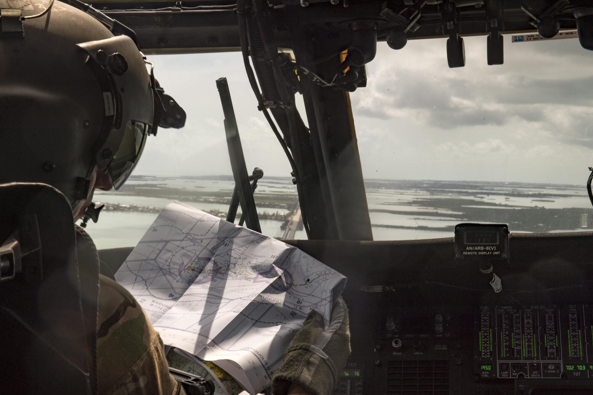 Capt. Nicholas Santoro, 66th Rescue Squadron HH-60G Pave Hawk pilot, checks an airspace map while flying over South Florida, Sept. 12, 2017. The 563d Rescue Group prepositioned aircraft and personnel in support of FEMA and U.S. Northern Command for rescue operations after Hurricane Irma made landfall in Florida. (U.S. Air Force photo by Staff Sgt. Ryan Callaghan)